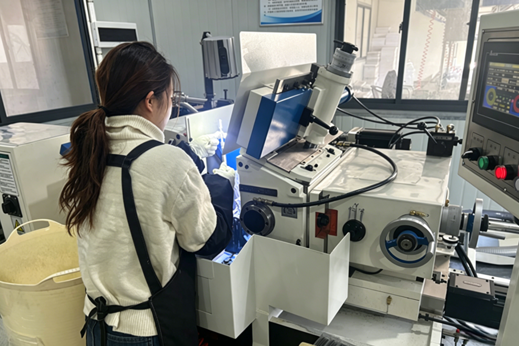 Precision Machining Tritenco precision machining process: quality control inspection of high-precision shafts using advanced grinding equipment in the factory